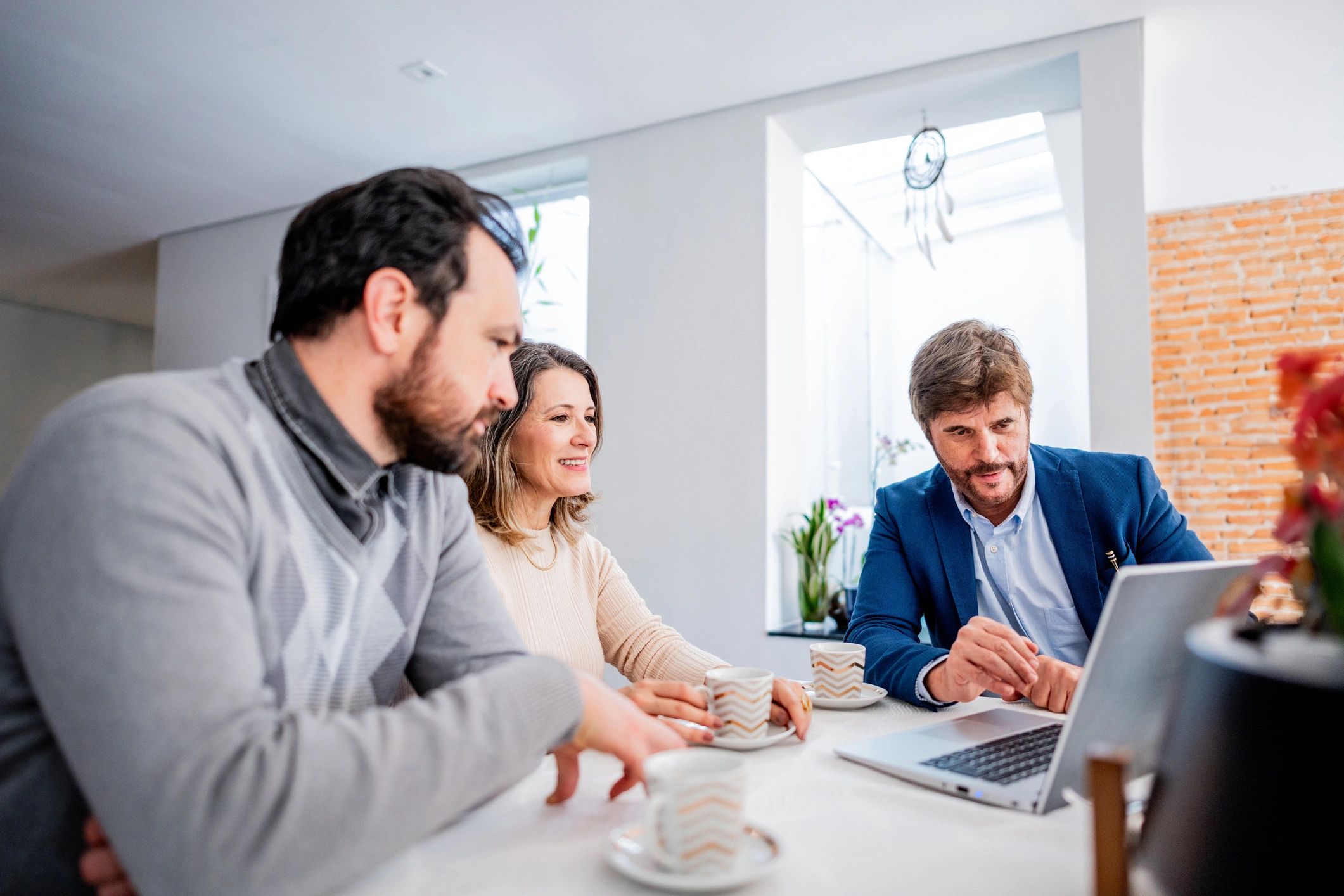 Insurance advisor meeting with a couple at home about Homra Insurance Group