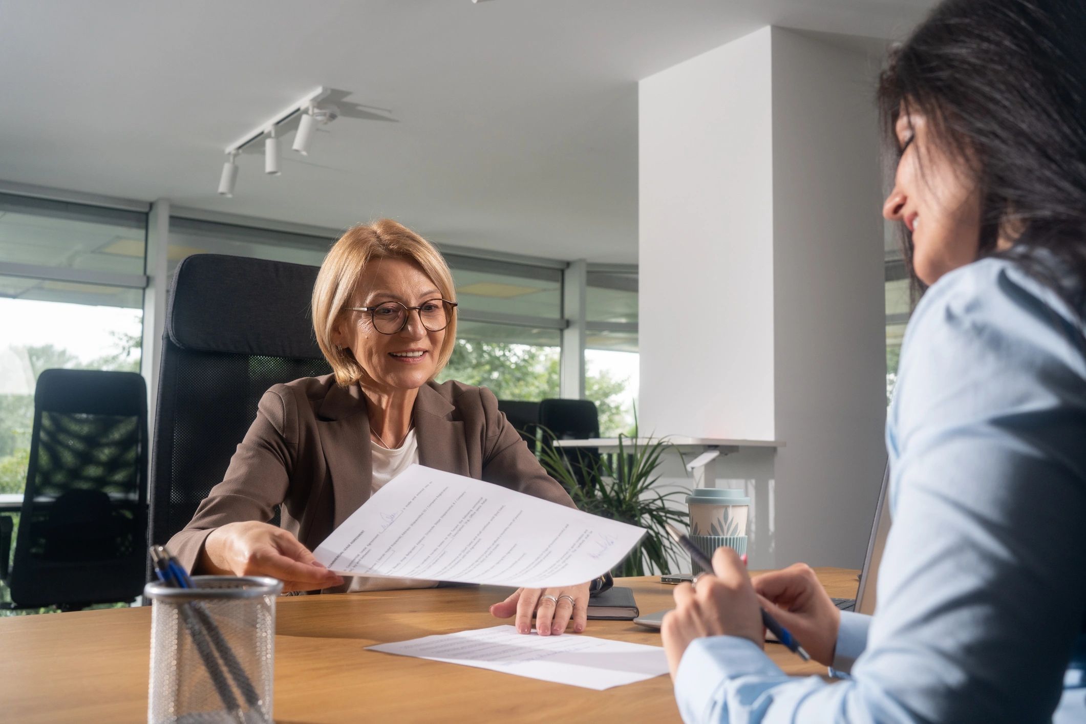 Happy insurance agent talking to her customer for Homra Insurance Group in Paducah, KY